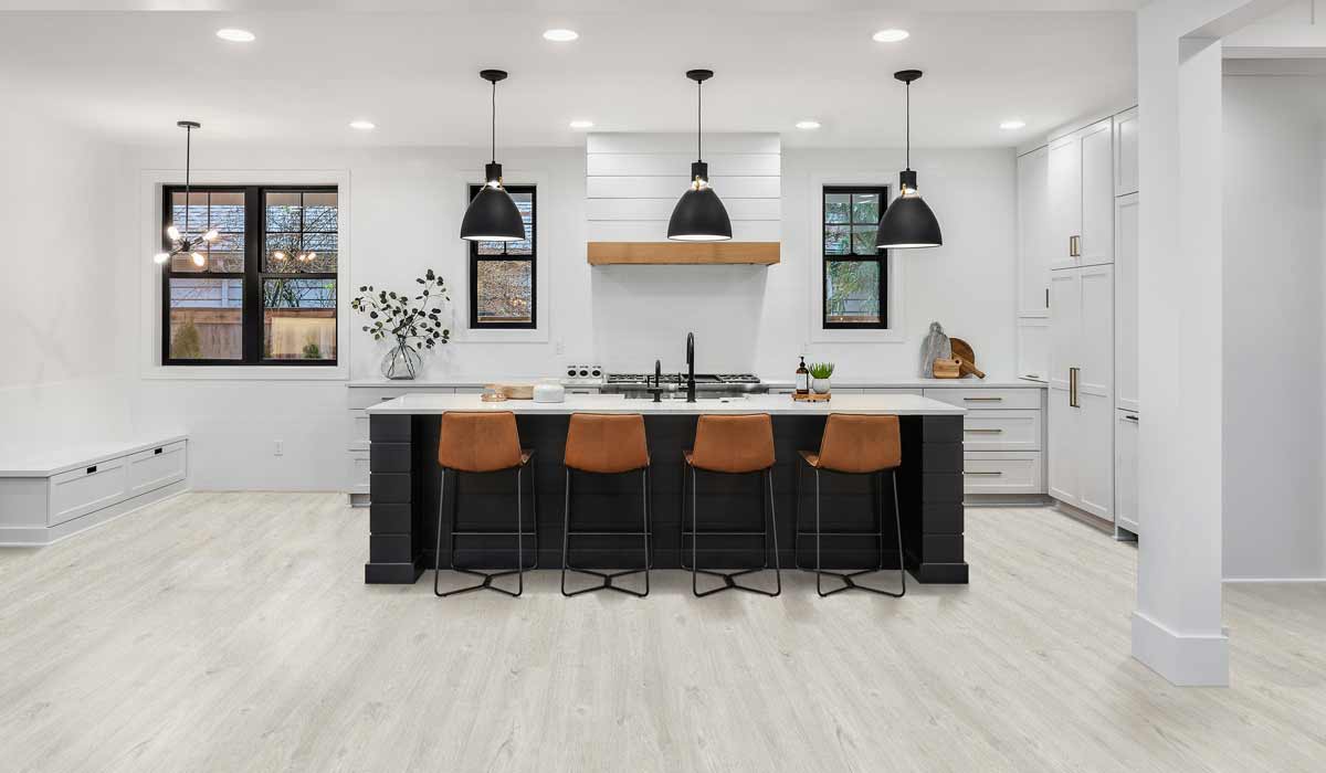 wood look laminate flooring in a kitchen with white cabinets and countertops